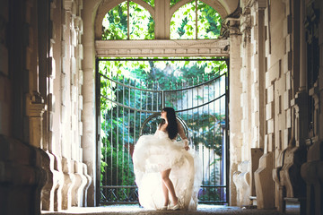 Sunny photo of the brunette bride in the wedding dress