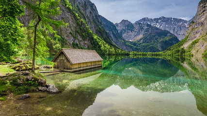 Fototapeta na wymiar Beautiful view of a small cottage on the lake Obersee in Alps, Germany