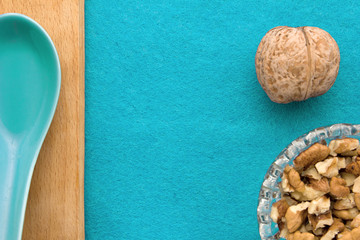 Fototapeta na wymiar Walnuts. Top view of wooden Board and blue background. For kitchen and menu 
