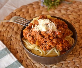 Spaghetti bolognese with meat tomato sauce and parmesan on a bowl