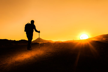 Fototapeta na wymiar sunset trekking shooting silhoutte