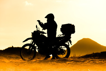 Obraz na płótnie Canvas silhouette of the mountain motor drive