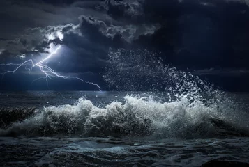 Wall murals Storm dark ocean storm with lgihting and waves at night