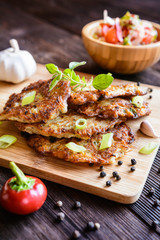 Fried celery pancakes with vegetable salad