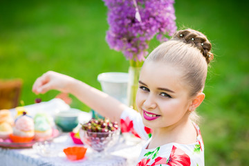 Girl decorating cupcakes in backyard