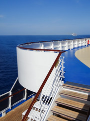 Detail of stairway on cruise ship  with blue Caribbean sea in background.