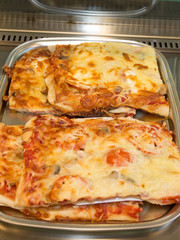 Piece of Italian pizza with many colors and ingredients