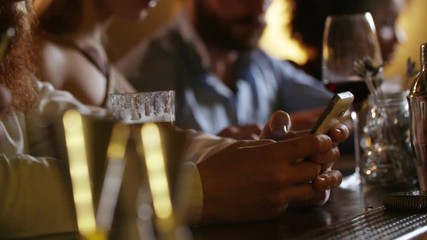 People using smartphone while sitting in luxury bar