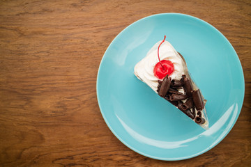 choccolate cake in blue dish on the woodden table