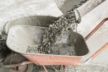 Motion Blur of Cement concrete pouring from cement truck into a cart mortar during for buildings...