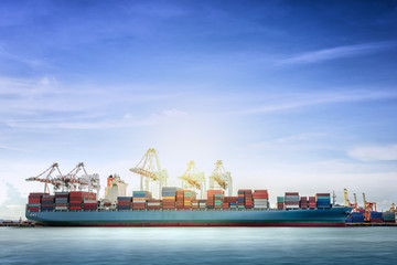 Logistics and transportation of International Container Cargo ship with working crane bridge in...