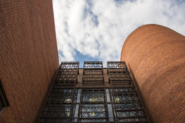 Walls, windows with figure pattern  and rounded tower of red brick Paleontological Museum, Moscow, Russia