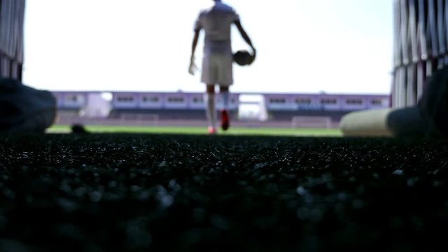 Silhouette of a football player going out to the stadium