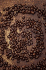 Dark roasted coffee beans arranged in a spiral formation 