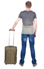 Back view of man with  green suitcase looking up. Rear view people collection.  backside view of person.  Isolated over white background. guy in the green t-shirt stands with a suitcase on wheels