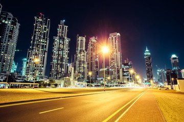 Fototapeta na wymiar Fantastic nighttime skyline: big futuristic city with illuminated skyscrapers. Downtown Dubai, United Arab Emirates. Colorful architecture background.