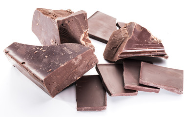 Chocolate blocks and pieces of chocolate bar isolated on a white