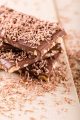 Stack from chocolate with nuts covered by sweet shavings