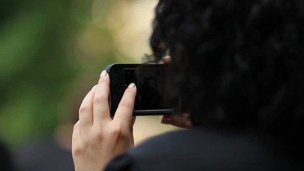 Woman taking pictures on smartphone, seizing moments of happiness, happy life