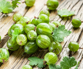 Gooseberries on the wooden table.