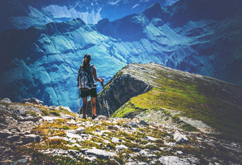 Hiker looking across valley in the Alps