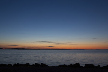 A colorful sunset by the lake in Finland. Image taken during sundown. 