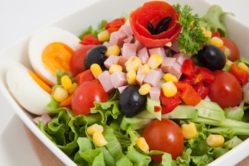 Obraz na płótnie Canvas Close up of vegetables salad with ham and eggs
