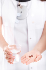 Obraz na płótnie Canvas pill and a glass of water, close-up