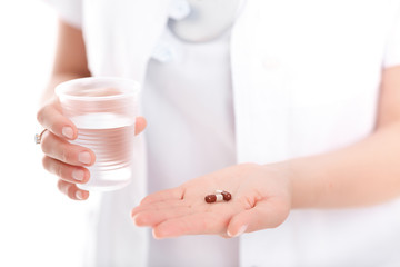  pill and a glass of water, close-up