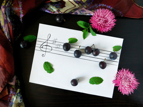 Composition made of plums related with the topic of music