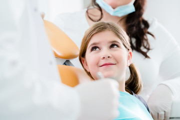 Dentist trearing child in his surgery