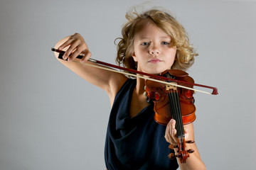 Girl playing a violin on white