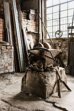 Old Workshop of blacksmith with anvil and horse harness