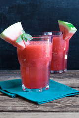 Healthy watermelon smoothie on a wood background