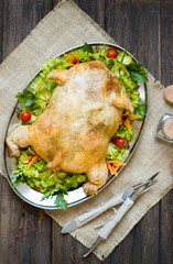 Served split roasted stuffed small turkey and vegetables,from above and blank space