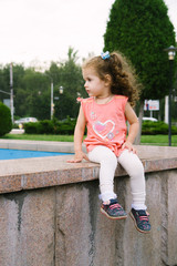 Little baby girl sitting on park