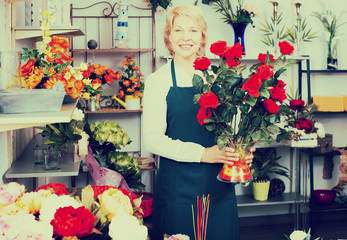 Florist with a bouquet of red roses