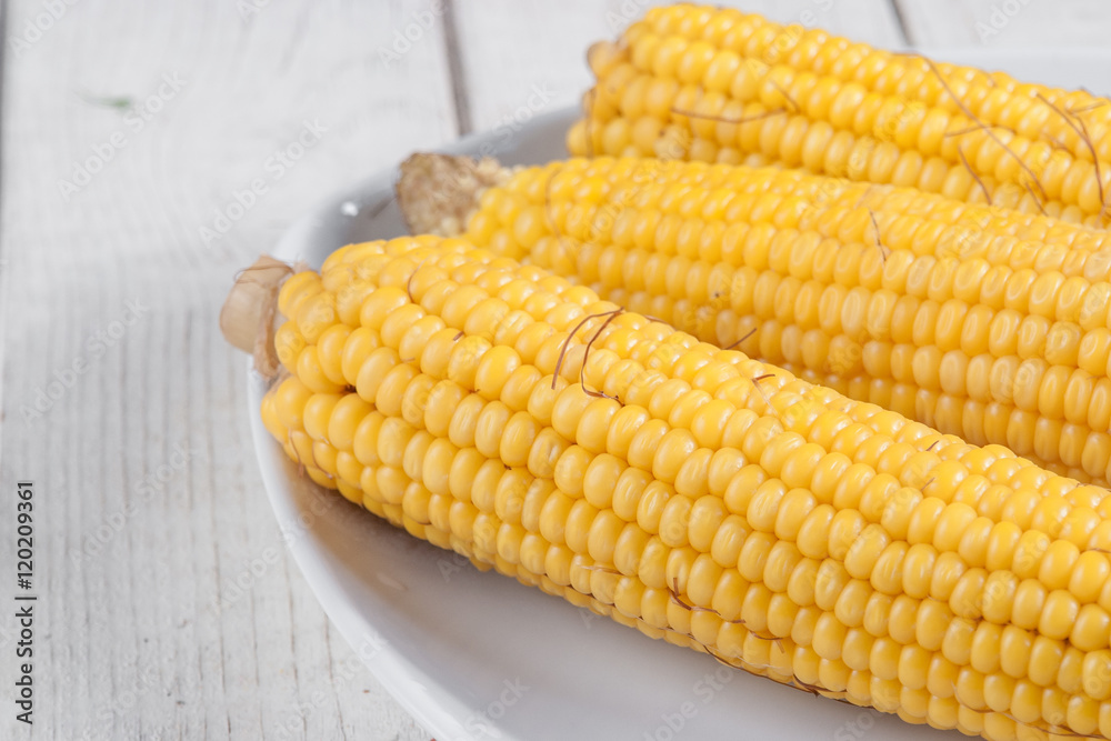 Poster three boiled corn on a plate