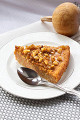 Piece of pumpkin pie with walnuts