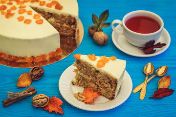 Carrot cake with red tea on blue background
