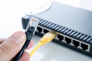 Network switch device and ethernet cables on white