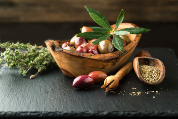 Olives in a bowl with spices oregano