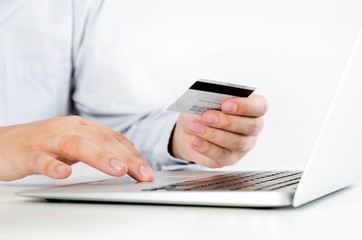 Man with laptop using credit card. Internet shopping.