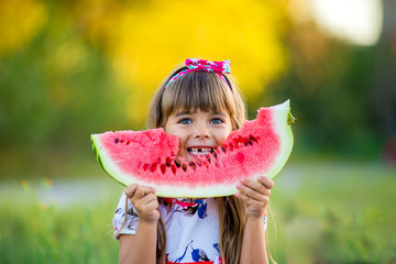 happy child eating watermelon - obrazy, fototapety, plakaty