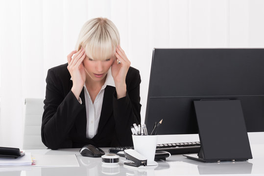 Businesswoman Suffering From Headache