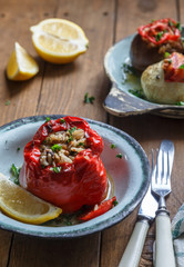 Bell peppers stuffed with rice and sauce on plate, selective focus