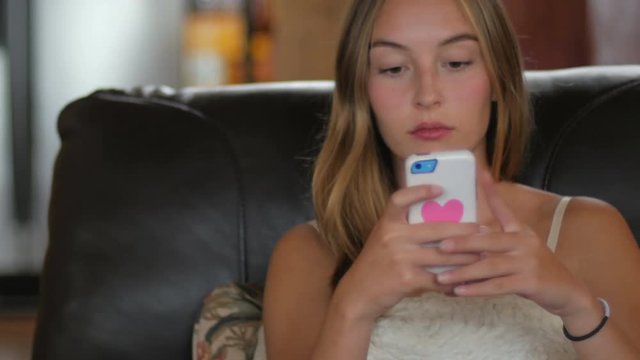 A young blond haired woman takes selfies of herself