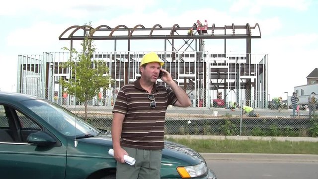 Construction Worker on Phone with Blueprints