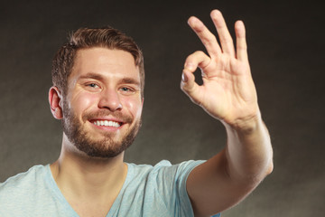 Handsome man guy giving ok sign gesture.