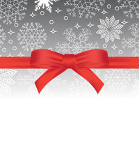 Greeting card with red bow on snowflakes background and copy space